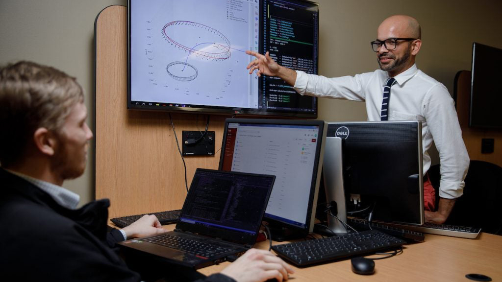 two faculty members viewing data rendering